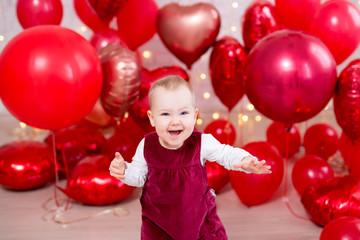 valentine's day concept - portrait of funny little baby girl with red balloons