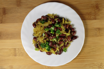 Stewed red beans with fried onions. Vegan food - red and black beans with fried onions, fried on an olive oil.