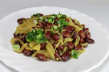 Stewed red beans with fried onions. Vegan food - red and black beans with fried onions, fried on an olive oil.