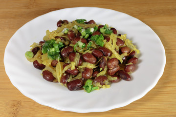 Stewed red beans with fried onions. Vegan food - red and black beans with fried onions, fried on an olive oil.