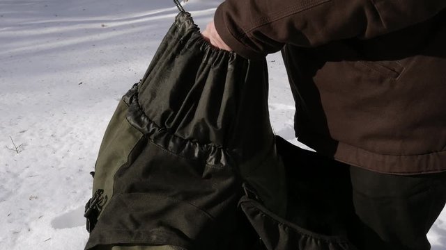 Tourist packing backpack. Searching for stuff at touristic backpack