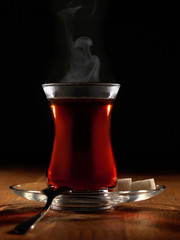Hot Turkish tea with spoon and two sugars.