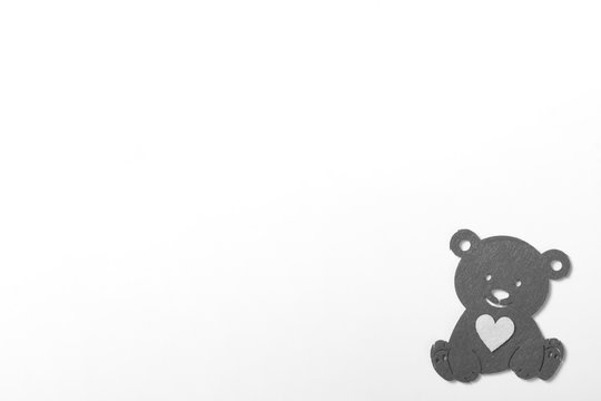 gray bear with a heart on a white background.Minimalism,copy space.Template for your design.
