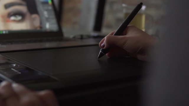 SLOW MOTION: Female Graphic Designer working with tablet and digital pen