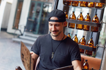 Shot of confident pleased Caucasian handsome male with happy smile choosing a dessert at menu,...