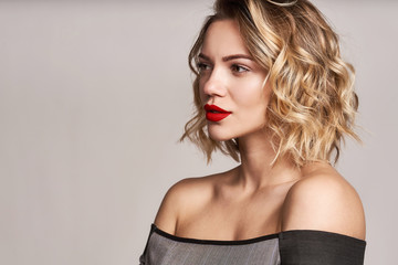 Beautiful stylish woman with red lips looking at camera