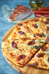 Slice of hot pizza large cheese lunch or dinner crust seafood meat topping sauce. with bell pepper vegetables delicious tasty fast food italian traditional on wooden board table classic in view