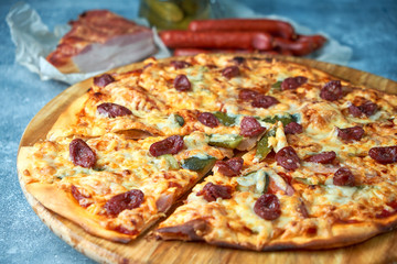 Slice of hot pizza large cheese lunch or dinner crust seafood meat topping sauce. with bell pepper vegetables delicious tasty fast food italian traditional on wooden board table classic in view
