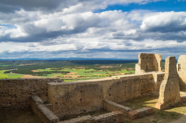 Fototapeta na wymiar Ruins of ancient fortress with farmlands in background