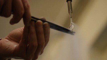 Diamond ring being steam cleaned at a jewellers workshop, in slow motion