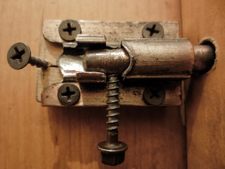Old metal bolt on the door. Door with old iron lock
