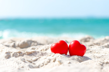 Valentine and Marry Concept. Two red hearts couple lovers for married on the sand summer beach,...