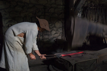 .Blacksmith forging in the traditional way, as in the past