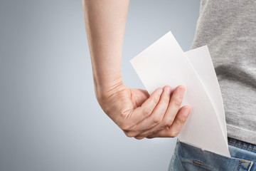 Hand putting two blank sheets of paper (tickets, flyers, invitations, coupons, banknotes, etc.)...