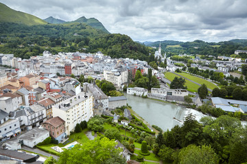 Naklejka premium Lourdes, France. The Sanctuary of Our Lady of Lourdes and river Gave de Pau. French city is located in southern France in the foothills of the Pyrenees mountains