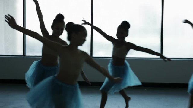 Portrait in silhouette of young ballet dancers in dance school