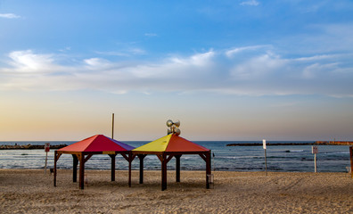 View of beach with colorful wooden arbors of Mediterranean sea in Tel Aviv, Israel