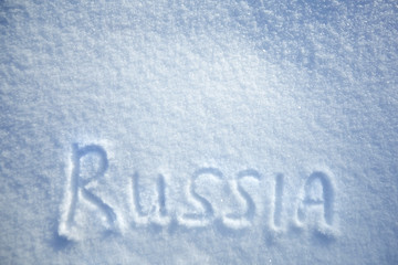 Inscription Russia, snowy background with copy space, top view