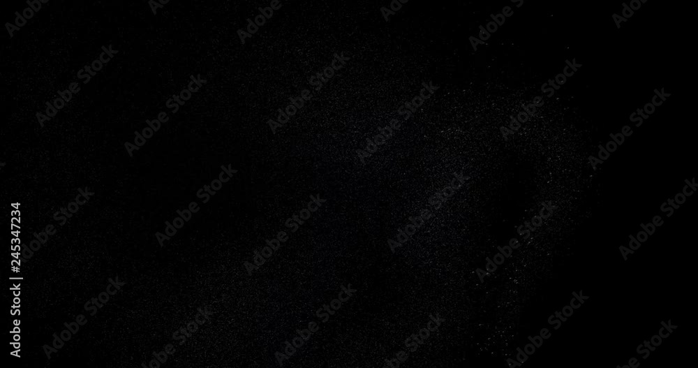 Poster particle system of powders moving in the black space, lights and granular elements collected in a cl