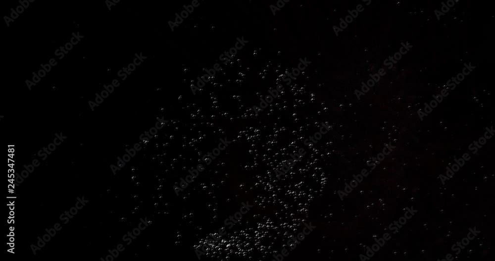 Poster particle system of powders moving in the black space, lights and granular elements collected in a cl