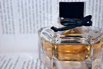 fragrance perfume scent jar woman black yellow orange bow ornament book drains the word liquid bottle page water spray white book he beautifully transparent material glass