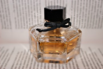 fragrance perfume scent jar woman black yellow orange bow ornament book drains the word liquid bottle page water spray white book he beautifully transparent material glass