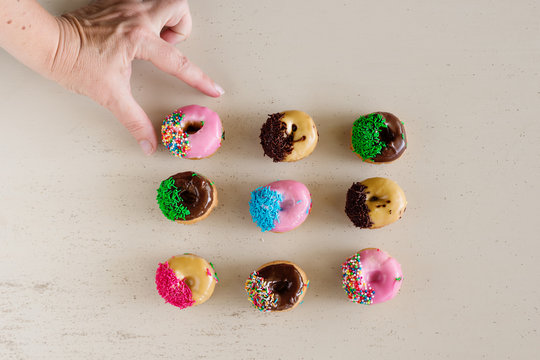hand reach to take a mini donut