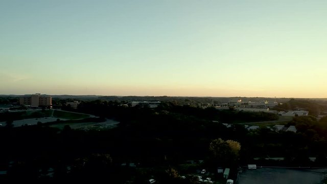 This High Definition drone aerial footage shows a sunset at altitude then pans to a suburban community in Pennsylvania.