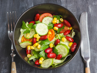 Vegetarian salad with red mexican beans, corn, arugula, cherry tomatoes and olive oil