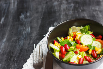 Vegetarian salad with red mexican beans, corn, arugula, cherry tomatoes and olive oil