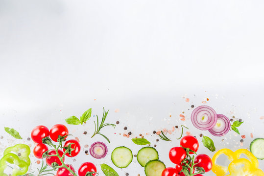 Vegan healthy food concept. Ingredients cooking spring vitamin salad. Fresh vegetable simple pattern, layout with tomatoes, onions, herbs and spices on white background. Top view banner copy space