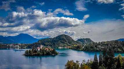 Naklejka na ściany i meble Aerial view of Bled lake near the Bled town in Slovenia. National park Triglav, part of Alps mountains called Julian Alps.