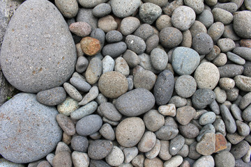 Big stones among smaller pebbles, in the garden.
