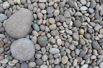 Big stones among smaller pebbles, in the garden.