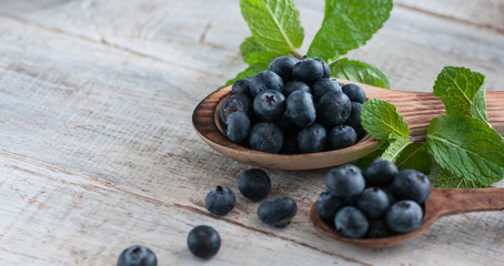 blueberries and various forest fruits, raspberries, strawberries. There are different types of wood on the table.