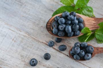 blueberries and various forest fruits, raspberries, strawberries. There are different types of wood on the table.