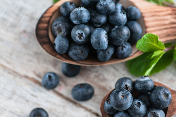 blueberries and various forest fruits, raspberries, strawberries. There are different types of wood on the table.