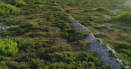 Village ruins, C4k aerial, reverse, drone shot, over old wall ruin, near Razanj town, on the...