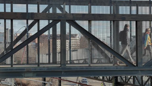 VALLADOLID, SPAIN - JANUARY 24, 2019: two people go through an elevated metal walkway