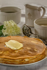 Russian pancakes with sour cream, butter and jam.