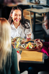 Three colleagues having dinner together after hard working day