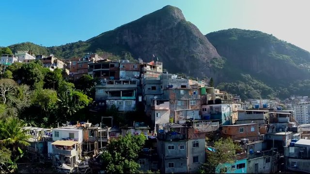 Majestic aerial favela rise and reveal of mountain setting in Rio de Janeiro