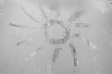 Images of the sun on a cold cloudy day on glass.