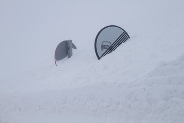 Driving in bad weather conditions, traffic signs hidden under the snow