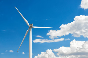 The wind generator is in bright cloudy sky. Eco energy concept.