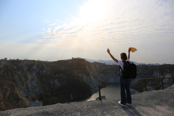 Amazing Thailand, Asian girl traveler with backpack enjoying and standing on mountains of The grand canyon chonburi