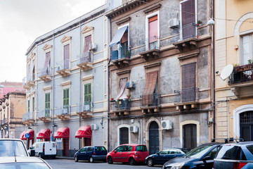 Fototapeta na wymiar Travel to Italy - historical street of Catania, Sicily, facade of ancient buildings.