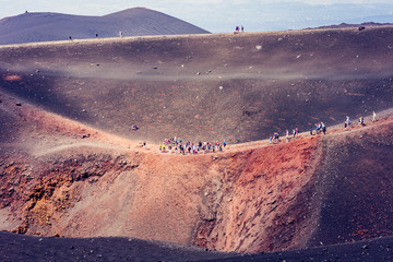 People walking on Mount Etna, active volcano on the east coast of Sicily, Italy.