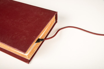 Old book with a battery charging cable