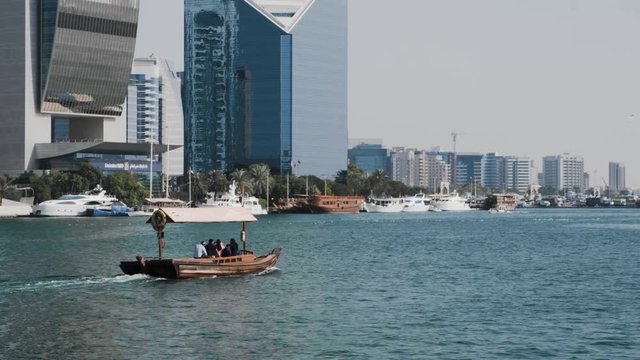 Dubai Creek Water Taxi. Vintage Arab boat on the background of skyscrapers